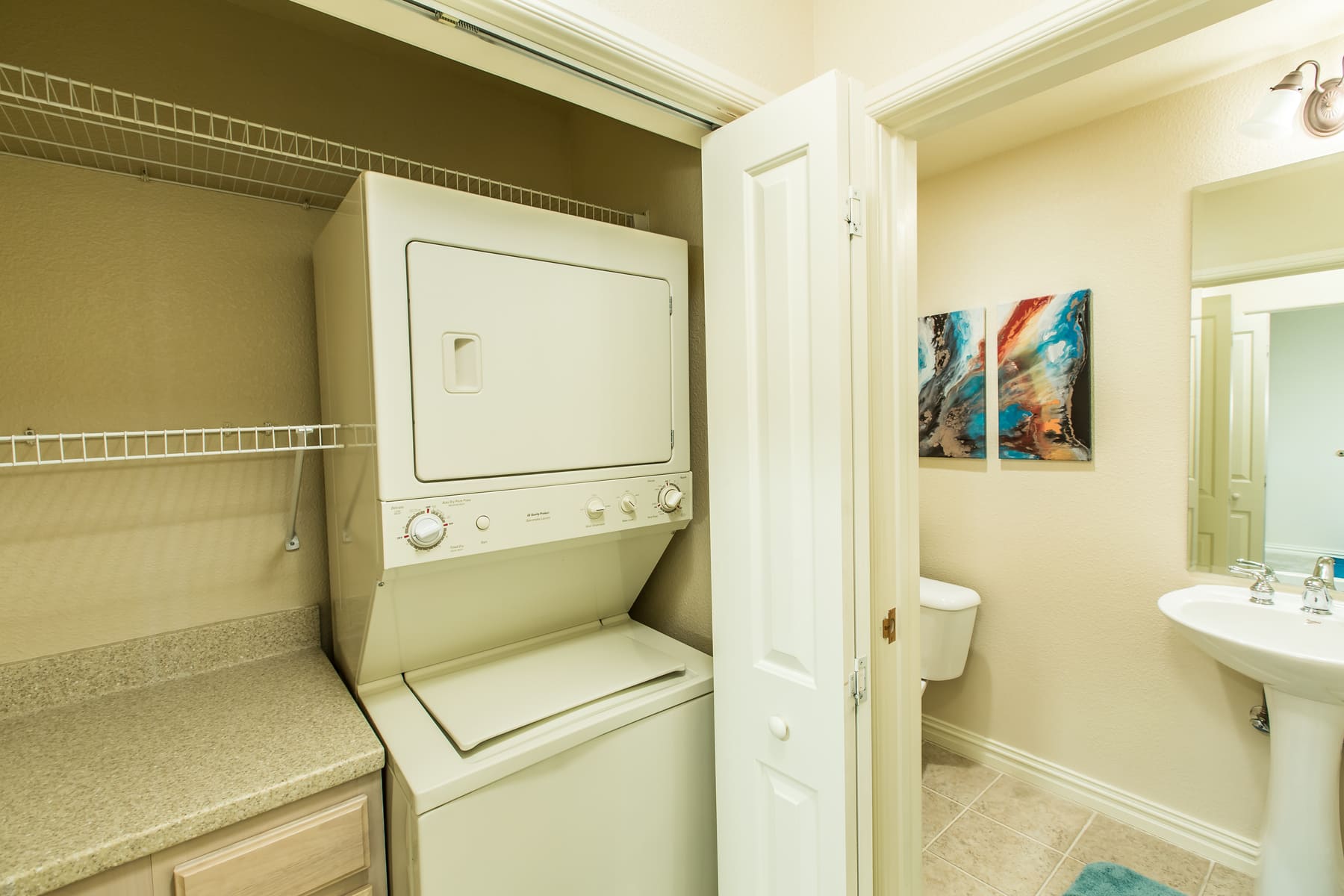 Stacked washer and dryer in hallway closet